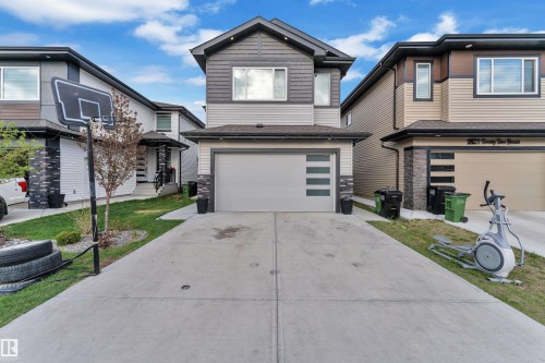 Contemporary two-story exterior featuring a two-tone facade with horizontal siding and stone accents - 1827 22 Street Nw, Edmonton, AB - Outdoor With Facade