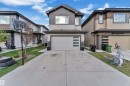 Contemporary two-story exterior featuring a two-tone facade with horizontal siding and stone accents - 1827 22 Street Nw, Edmonton, AB  - Outdoor With Facade 