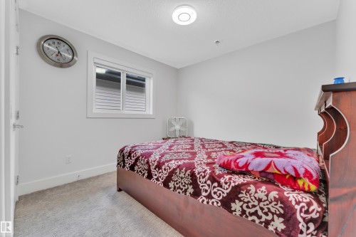 Bedroom with light gray walls, white trim, and light gray carpet - 1827 22 Street Nw, Edmonton, AB - Indoor Photo Showing Bedroom