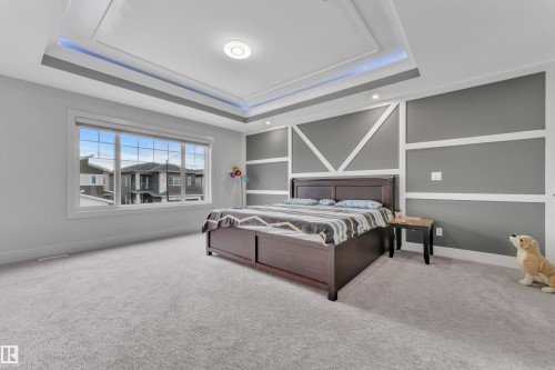 Recessed lighting and a tray ceiling with accent lighting provide illumination - 1827 22 Street Nw, Edmonton, AB - Indoor Photo Showing Bedroom