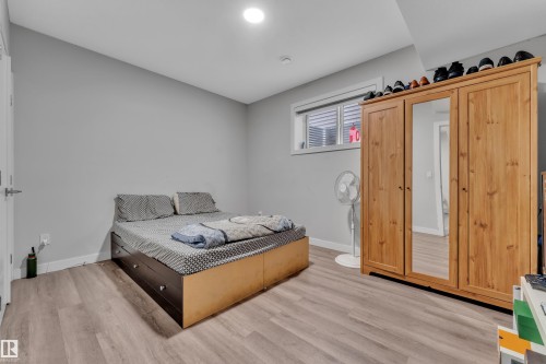 Spacious room featuring light wood-finish flooring and neutral wall tones - 1827 22 Street Nw, Edmonton, AB - Indoor Photo Showing Bedroom