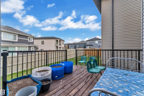 Elevated wood-finish deck featuring dark metal railings and a privacy wall with horizontal siding - 1827 22 Street Nw, Edmonton, AB - Outdoor With Deck Patio Veranda With Exterior