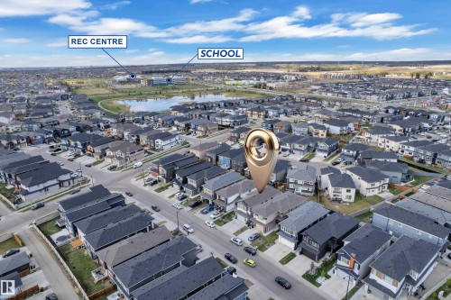 Aerial perspective showcasing a residential neighborhood with a prominent central lake and surrounding green spaces - 1827 22 Street Nw, Edmonton, AB - Outdoor With View