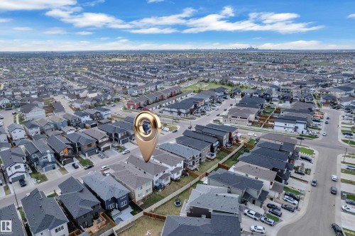 Aerial perspective showcasing a residential neighborhood with diverse housing styles and a distant skyline - 1827 22 Street Nw, Edmonton, AB - Outdoor With View