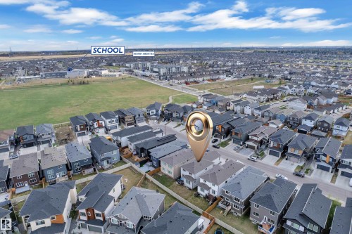 Aerial view of a residential neighborhood with detached homes, featuring varied architectural styles and dark-toned roofs - 1827 22 Street Nw, Edmonton, AB - Outdoor With View