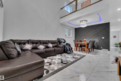 Open-concept living area with soaring ceilings and light-toned walls - 1827 22 Street Nw, Edmonton, AB - Indoor Photo Showing Living Room