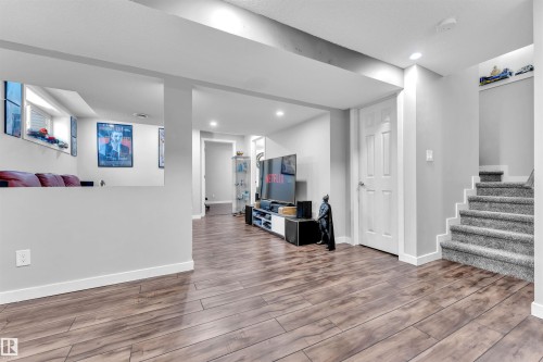 Spacious room featuring wood-look flooring, light grey walls, and recessed lighting - 8108 217 Street, Edmonton, AB - Indoor Photo Showing Other Room