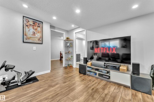 Living area featuring recessed lighting, light-colored walls, and wood-style flooring - 8108 217 Street, Edmonton, AB - Indoor