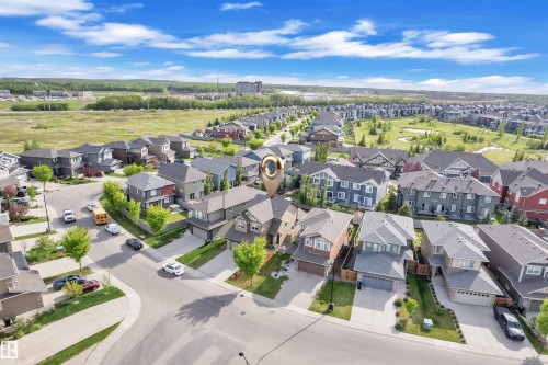 Elevated view of a residential neighborhood featuring detached homes with various architectural styles, paved streets, and green spaces - 8108 217 Street, Edmonton, AB - Outdoor With View