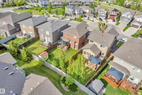 This property features a well-maintained yard with mature trees, a wooden deck, and a gazebo - 8108 217 Street, Edmonton, AB - Outdoor With View