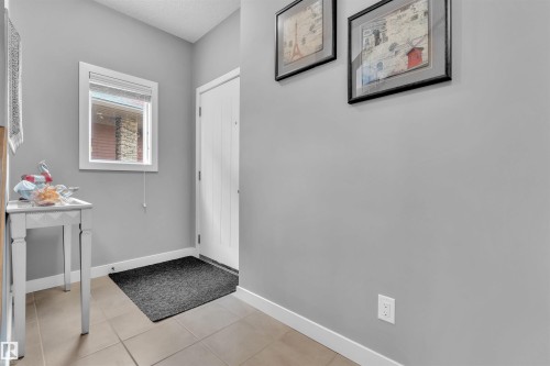 Entryway with tiled flooring, a window, and a white paneled door - 8108 217 Street, Edmonton, AB - Indoor Photo Showing Other Room