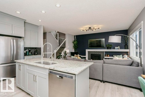 2423 16 Avenue, Edmonton, AB - Indoor Photo Showing Kitchen With Fireplace With Double Sink