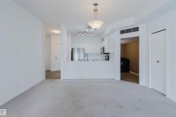 Open-concept living area with light-toned carpeting - 