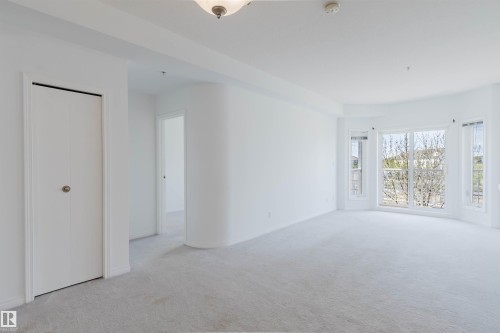Spacious room featuring light-toned carpeting and white painted walls - 308 4316 139 Avenue, Edmonton, AB 