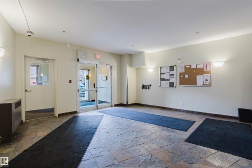 Entrance foyer featuring large format stone tile flooring - 308 4316 139 Avenue, Edmonton, AB 