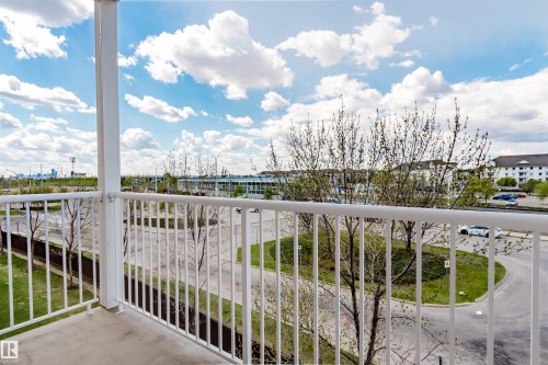 Outdoor balcony featuring a painted concrete floor and white metal railings - 308 4316 139 Avenue, Edmonton, AB 