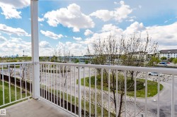 Outdoor balcony featuring a painted concrete floor and white metal railings - 