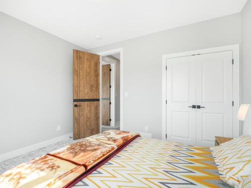 Light gray walls with white trim - 15 Elwyck Gate, Spruce Grove, AB - Indoor Photo Showing Bedroom