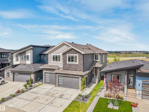 Contemporary two-story residence featuring a multi-textured facade with stone and siding accents - 15 Elwyck Gate, Spruce Grove, AB - Outdoor With Facade
