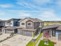 Contemporary two-story residence featuring a multi-textured facade with stone and siding accents - 15 Elwyck Gate, Spruce Grove, AB  - Outdoor With Facade 