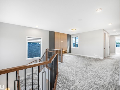 Upper-level landing featuring a contemporary wood and metal railing, recessed lighting, and a textured carpet - 15 Elwyck Gate, Spruce Grove, AB - Indoor Photo Showing Other Room