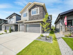 Modern two-story residence featuring a stone and siding exterior - 