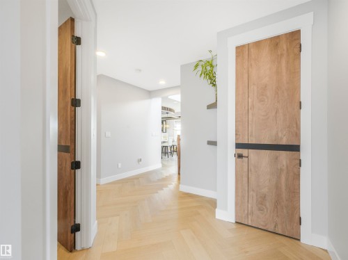Hallway featuring wood-finish herringbone flooring, recessed lighting, and light gray wall tones - 15 Elwyck Gate, Spruce Grove, AB - Indoor Photo Showing Other Room