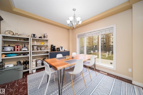 Dining space featuring a tray ceiling and a multi-light chandelier - 1508 Cunningham Cape Cape, Edmonton, AB - Indoor Photo Showing Dining Room