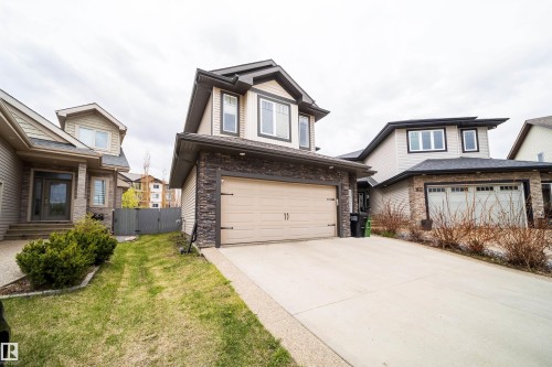 Two-story residence featuring a neutral exterior siding and a dark roof - 1508 Cunningham Cape Cape, Edmonton, AB - Outdoor With Facade