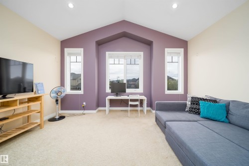 Varying ceiling heights with recessed lighting, complemented by a central window and two flanking windows - 1508 Cunningham Cape Cape, Edmonton, AB - Indoor