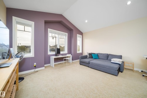 Vaulted ceiling room featuring light-colored carpeting, multiple windows, and recessed lighting - 1508 Cunningham Cape Cape, Edmonton, AB - Indoor