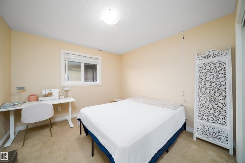 Bedroom with soft beige walls, carpeting, and a flush-mount ceiling light - 1508 Cunningham Cape Cape, Edmonton, AB - Indoor Photo Showing Bedroom
