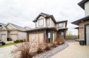 Contemporary two-story residence featuring light-colored siding and dark stone veneer accents - 1508 Cunningham Cape Cape, Edmonton, AB  - Outdoor 