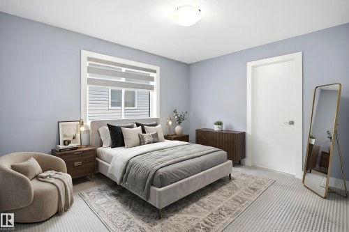 Bedroom featuring a large window with layered blinds, light blue walls, and a white ceiling - 3909 49 Ave, Beaumont, AB - Indoor Photo Showing Bedroom