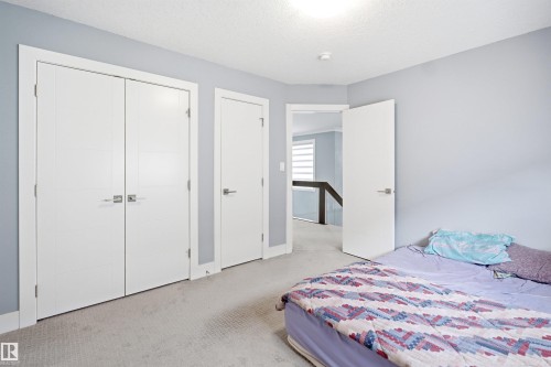 Wall-to-wall carpeted room with light blue walls and white trim - 3909 49 Ave, Beaumont, AB - Indoor Photo Showing Bedroom