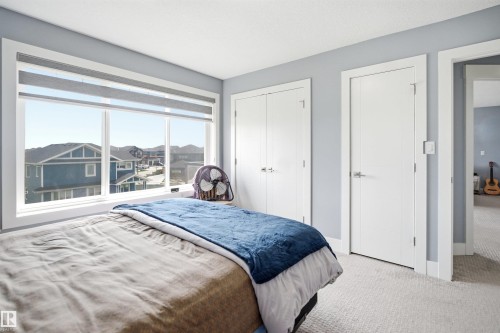 Expansive window with roller shades - 3909 49 Ave, Beaumont, AB - Indoor Photo Showing Bedroom