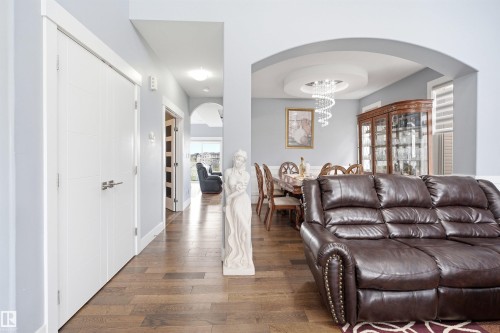 Archway entry to dining area with a circular tray ceiling and chandelier - 3909 49 Ave, Beaumont, AB - Indoor Photo Showing Living Room