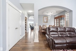 Archway entry to dining area with a circular tray ceiling and chandelier - 
