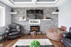 Feature wall with stacked stone finish and integrated electric fireplace - 