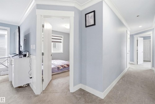 Hallway featuring light blue walls, white trim, recessed lighting, and carpet flooring - 3909 49 Ave, Beaumont, AB - Indoor