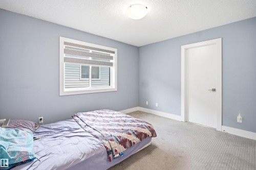 Light blue painted walls with white trim and a neutral carpeted floor - 3909 49 Ave, Beaumont, AB - Indoor Photo Showing Bedroom