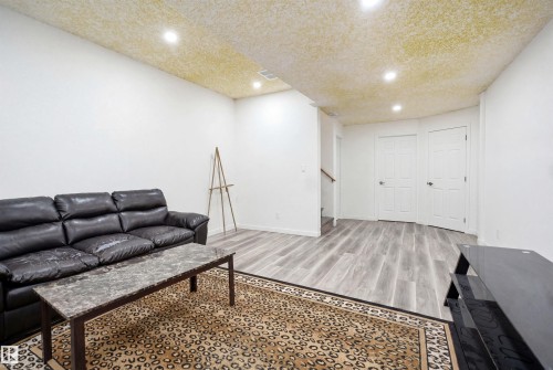 Open living space featuring light-toned wood-finish flooring, recessed lighting, and white walls - 3909 49 Ave, Beaumont, AB - Indoor