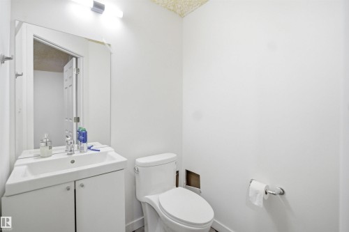 White vanity with an integrated basin, chrome faucet, and mirrored medicine cabinet - 3909 49 Ave, Beaumont, AB - Indoor Photo Showing Bathroom