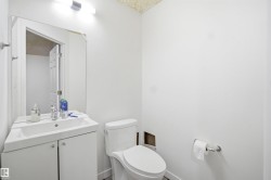 White vanity with an integrated basin, chrome faucet, and mirrored medicine cabinet - 