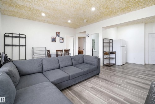 Open-concept living area featuring light wood-finish flooring, white walls, and recessed lighting - 3909 49 Ave, Beaumont, AB - Indoor Photo Showing Living Room