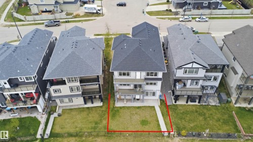 Contemporary multi-level residence featuring a gray and white exterior with dark trim accents - 3909 49 Ave, Beaumont, AB - 