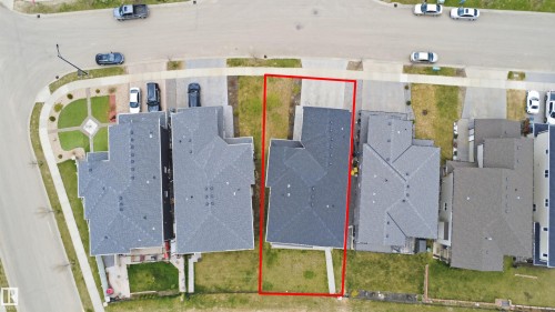 Detached property featuring a dark shingle roof, a front-facing driveway, and a backyard with a grass lawn - 3909 49 Ave, Beaumont, AB - 