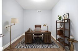 Dedicated room featuring wood-finish flooring, light gray walls, white baseboards, and a white ceiling with a flush-mount light fixture - 
