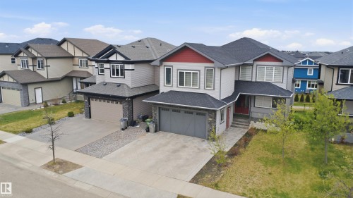 Contemporary two-story residence featuring light gray siding and a dark shingle roof - 3909 49 Ave, Beaumont, AB - Outdoor With Facade