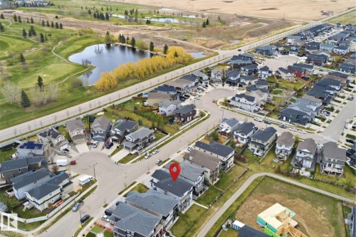 Residential neighborhood featuring a cul-de-sac street pattern, established homes with dark roofs, and proximity to a golf course with a pond and mature trees - 3909 49 Ave, Beaumont, AB - Other